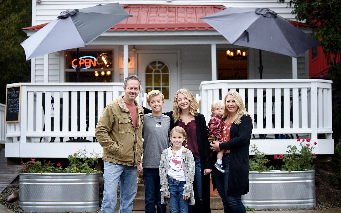 The Peerman family gather for a photo in front of the new Farmhouse Inn &amp; Kitchen in downtown Whitefish on Tuesday morning, Sept. 17. From left are Steve, Malakai, Bailey, Eli and Brandi. Havana is in the front. (Brenda Ahearn/Daily Inter Lake)