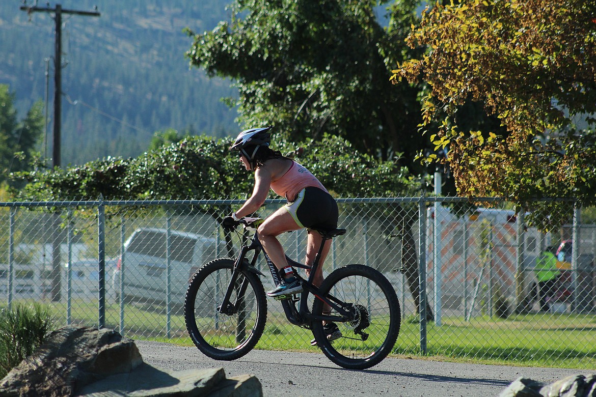 DAWN LEV taking off on her mountain bike for the long heat bike portion. (John Dowd/ Clark Fork Valley Press)