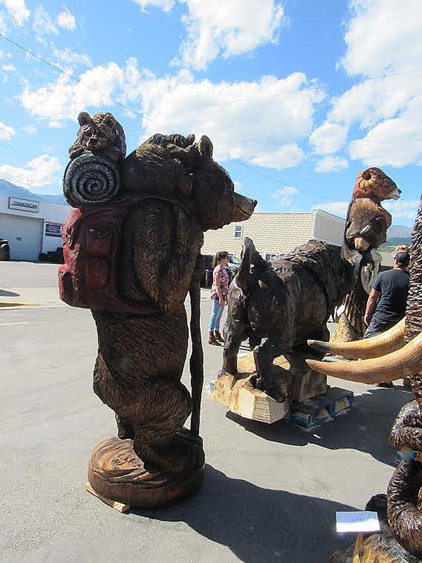 STEVEN HIGGINS' &quot;Daddy Time&quot; that portrayed a backpacking bear placed third in the Masterpiece group at the 2019 Third Annual International Chainsaw Carving Championships in LIbby. Higgins was second in the People's Choice category and he was the 'King of the Auction' with the most money sold in the quick carve auctions. (Photo courtesy Kootenai Country Montana)