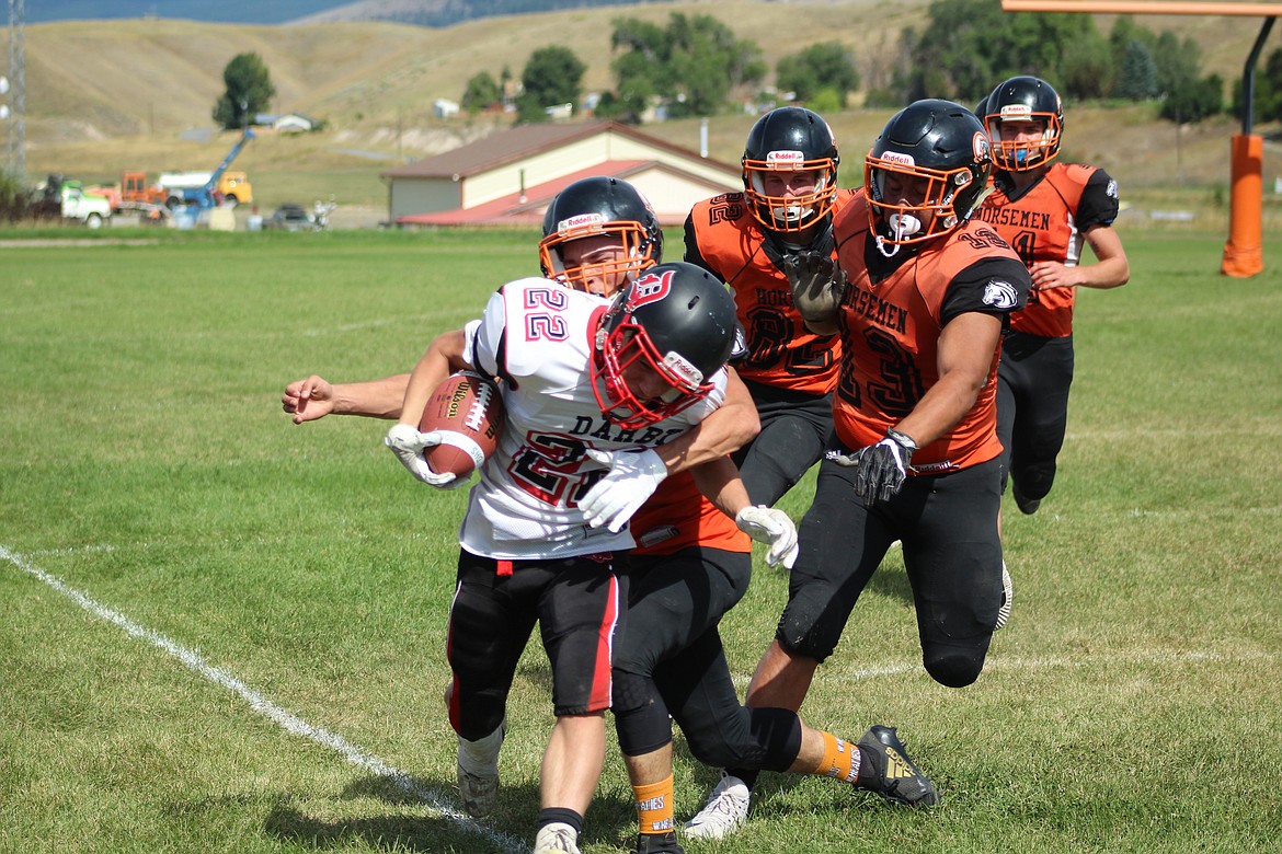 A GROUP of Plains Horsemen gang tackle a Darby ballcarrier last Saturday in their home game. (John Dowd/Clark Fork Valley Press)