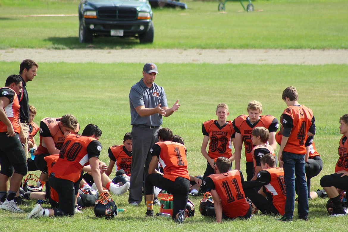 THE HORSEMEN going over plays at halftime Saturday against Darby. (John Dowd/Clark Fork Valley Press)