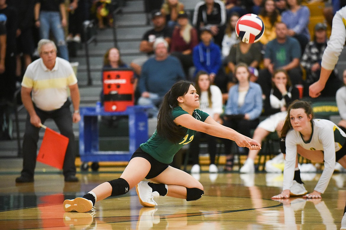 Jasmine Matern dives for the bump against Columbia Falls. (Daniel McKay/Whitefish Pilot)