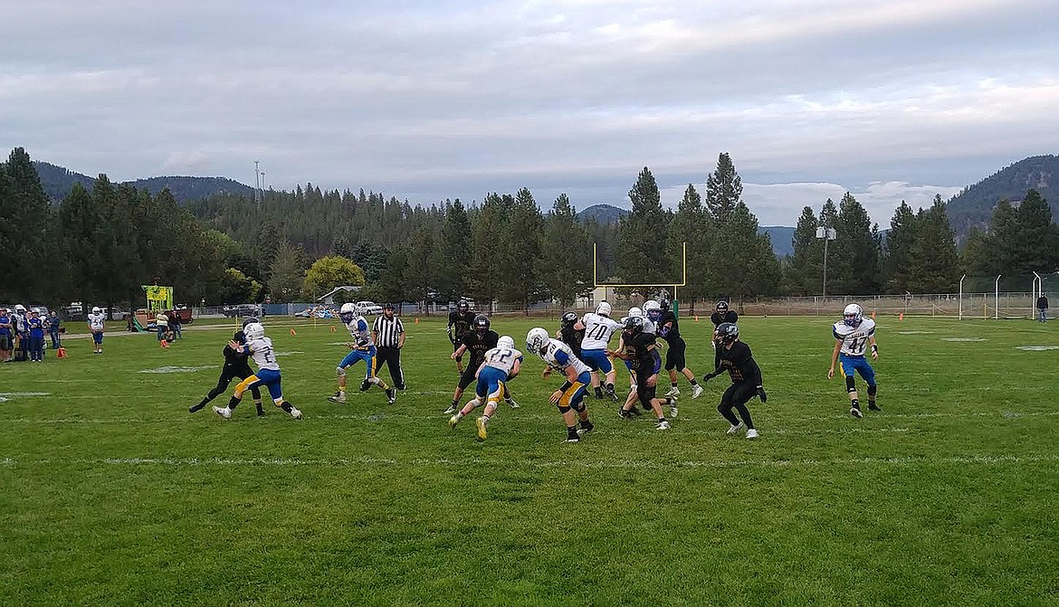 MEMBERS OF the St. Regis, Montana/Mullan, Idaho football team prepare to tackle a ballcarrier from Victor, Montana, during Friday night's game. The Tigers rolled to a 52-6 win over Victor as they improved to 3-0. (Chuck Bandel/Mineral Independent)