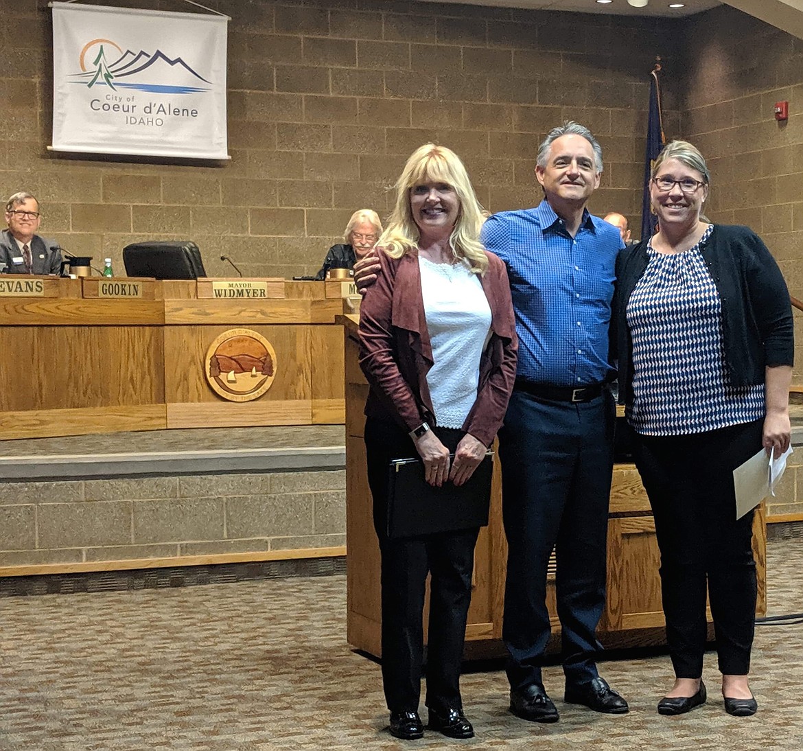 Kootenai County Task Force on Human Relations president Christie Wood (left) and community activist Laura Tenneson accept Coeur d'Alene Mayor Steve Widmyer's proclamation recognizing Constitution Week. Wood and Tenneson advocated for the city to adopt a welcoming invitation for diversity. (Photo by Jessica Mahuron)