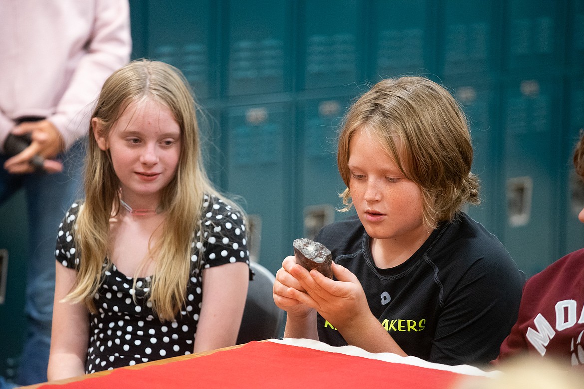 Students admire a Blackfeet artifact during a presentation by artist and elder Albertine Crow Shoe last week at Whitefish Middle School. (Daniel McKay/Whitefish Pilot)