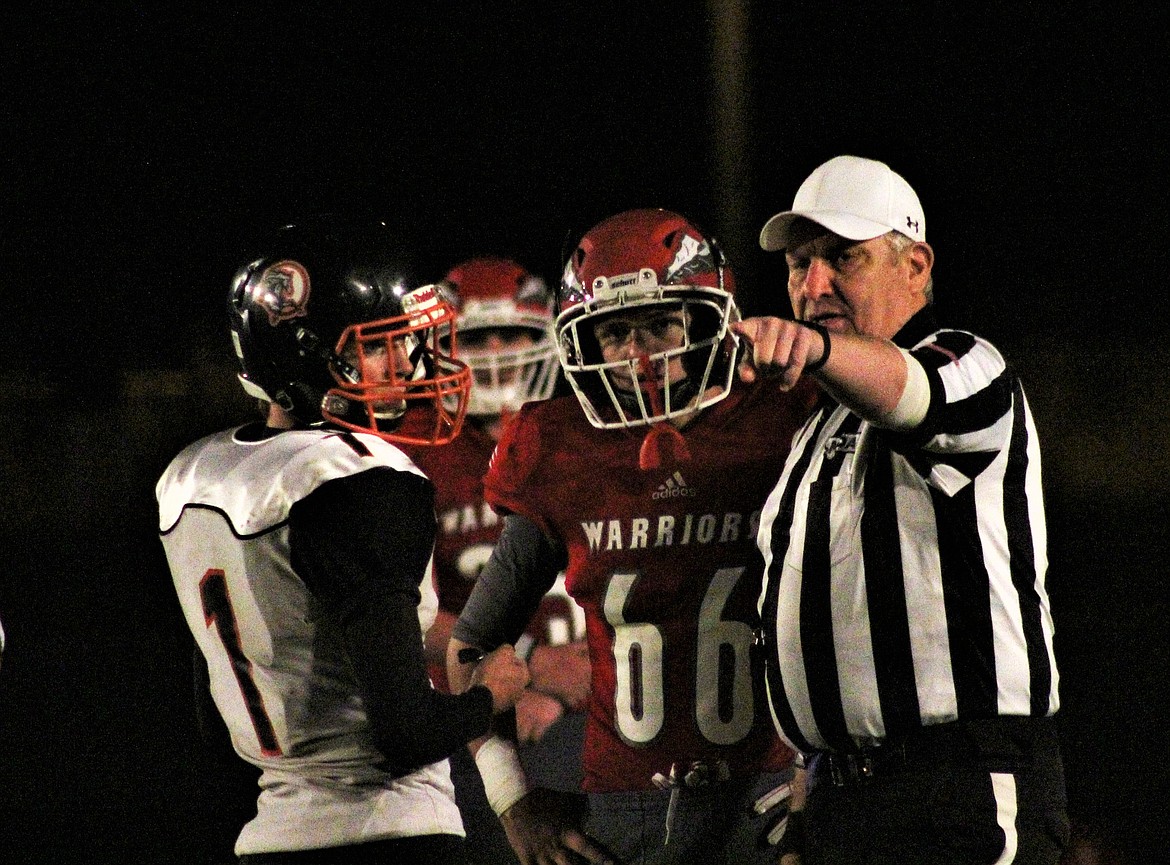 CAPTAINS CJ Forgey and Treydon Brouillette meeting with the referee over a few flags. (John Dowd/Clark Fork Valley Press)