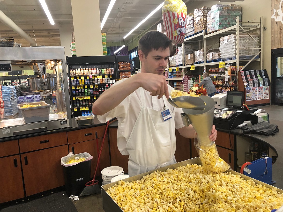 Shane Maurer of Super 1 Foods bags popcorn. (Photos/Keith Erickson)