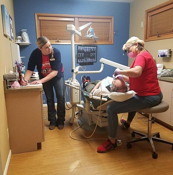 Lindsay Von Behern (left) and Jay Langston (right) of Advanced Family Dentistry perform free dental services to a local veteran during 2017's Freedom Day USA. The Coeur d'Alene dental team is once again participating in the yearly event this Thursday. (File photo by HOLLY PASZCZYNSKA/Press)