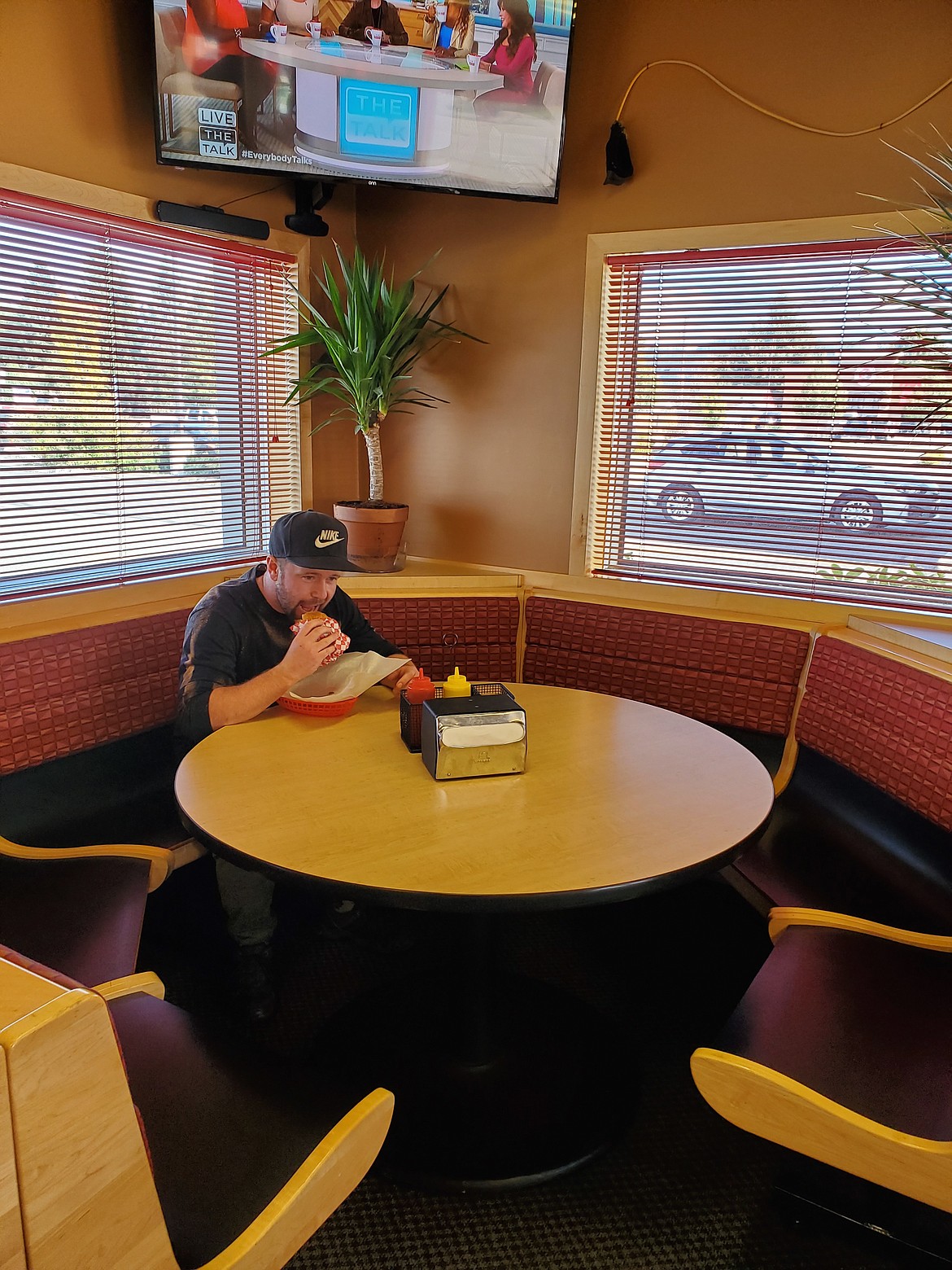 Courtesy photo
Owner Jake Latuseck enjoying his usual double delicious with bacon and jalape&ntilde;os at The Surf Shack, which is now open on East Appleway in Coeur dAlene.