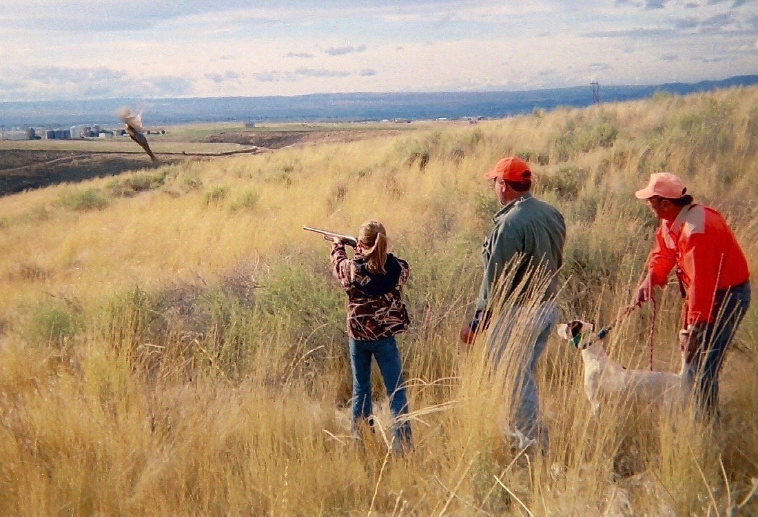 (Courtesy IDAHO DEPARTMENT OF FISH AND GAME)
A youth hunter and two mentors flush a rooster during an Idaho youth hunt.