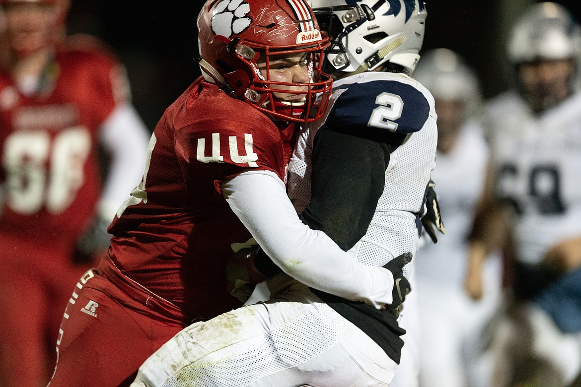 (Photo courtesy of JASON DUCHOW PHOTOGRAPHY)
Senior Sam Puckett wraps up Lake City running back Uriah Chavez during the game Friday night.