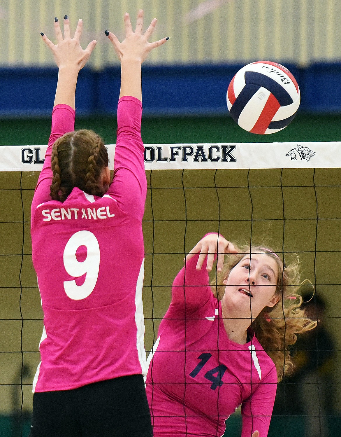 Glacier's Emma Anderson (14) spikes against Missoula Sentinel's Alexis Umland (9) at Glacier High School on Tuesday. (Casey Kreider/Daily Inter Lake)