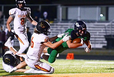 Glacier running back Jake Rendina (33) dives into the end zone for the game-winning touchdown in the fourth quarter against Missoula Hellgate at Legends Stadium on Friday. Glacier won, 35-28. (Casey Kreider/Daily Inter Lake)