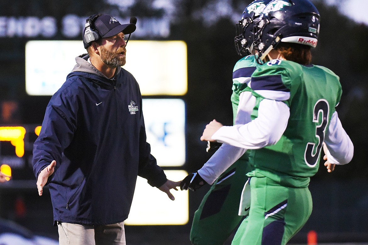 Glacier head coach Grady Bennett congratulates the team after a first-quarter touchdown against Missoula Hellgate at Legends Stadium on Friday. (Casey Kreider/Daily Inter Lake)