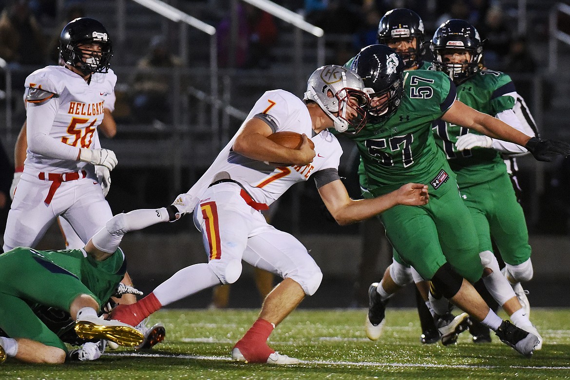 Missoula Hellgate quarterback Rollie Worster (7) is brought down by Glacier&#146;s Hunter Karlstad (15, left) and Henry Nuce (57) at Legends Stadium on Friday. (Casey Kreider/Daily Inter Lake)