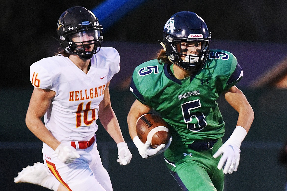 Glacier wide receiver Drew Deck (5) heads to the end zone on a 70-yard touchdown reception in the first quarter against Missoula Hellgate at Legends Stadium on Friday. Glacier won, 35-28. (Casey Kreider/Daily Inter Lake)