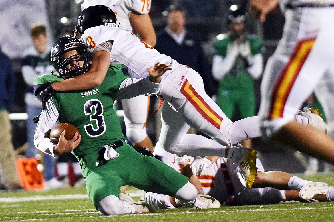 Glacier quarterback JT Allen (3) is tackled by Missoula Hellgate defensive back Robert Johnson (18) at Legends Stadium on Friday. (Casey Kreider/Daily Inter Lake)