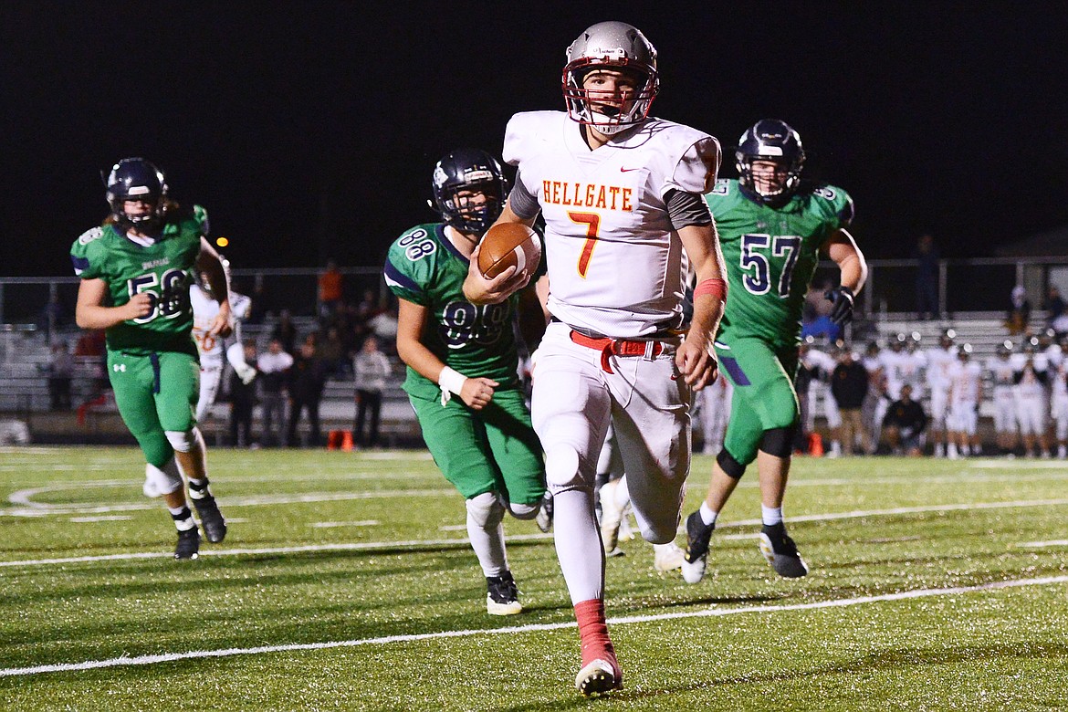 Missoula Hellgate quarterback Rollie Worster (7) heads to the end zone on a first-quarter touchdown run against Glacier at Legends Stadium on Friday. (Casey Kreider/Daily Inter Lake)