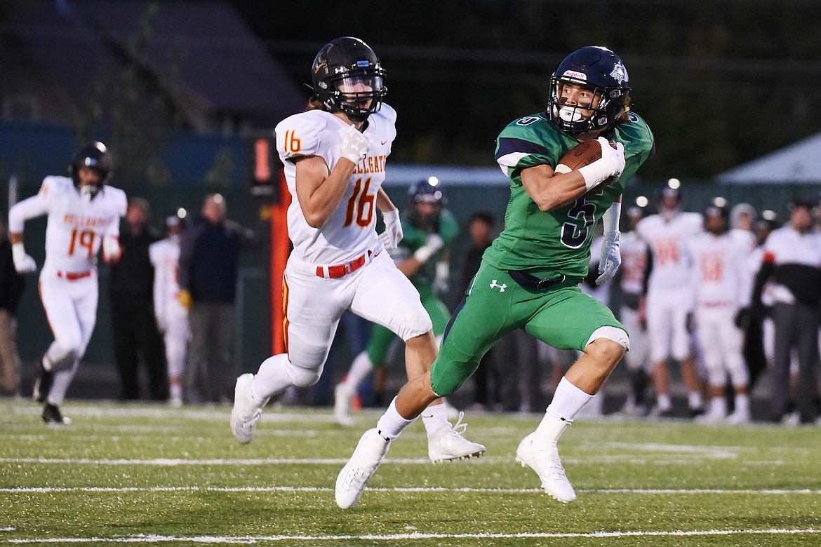 Glacier wide receiver Drew Deck (5) heads to the end zone on a 70-yard touchdown reception in the first quarter against Missoula Hellgate at Legends Stadium on Friday. Glacier won, 35-28. (Casey Kreider/Daily Inter Lake)