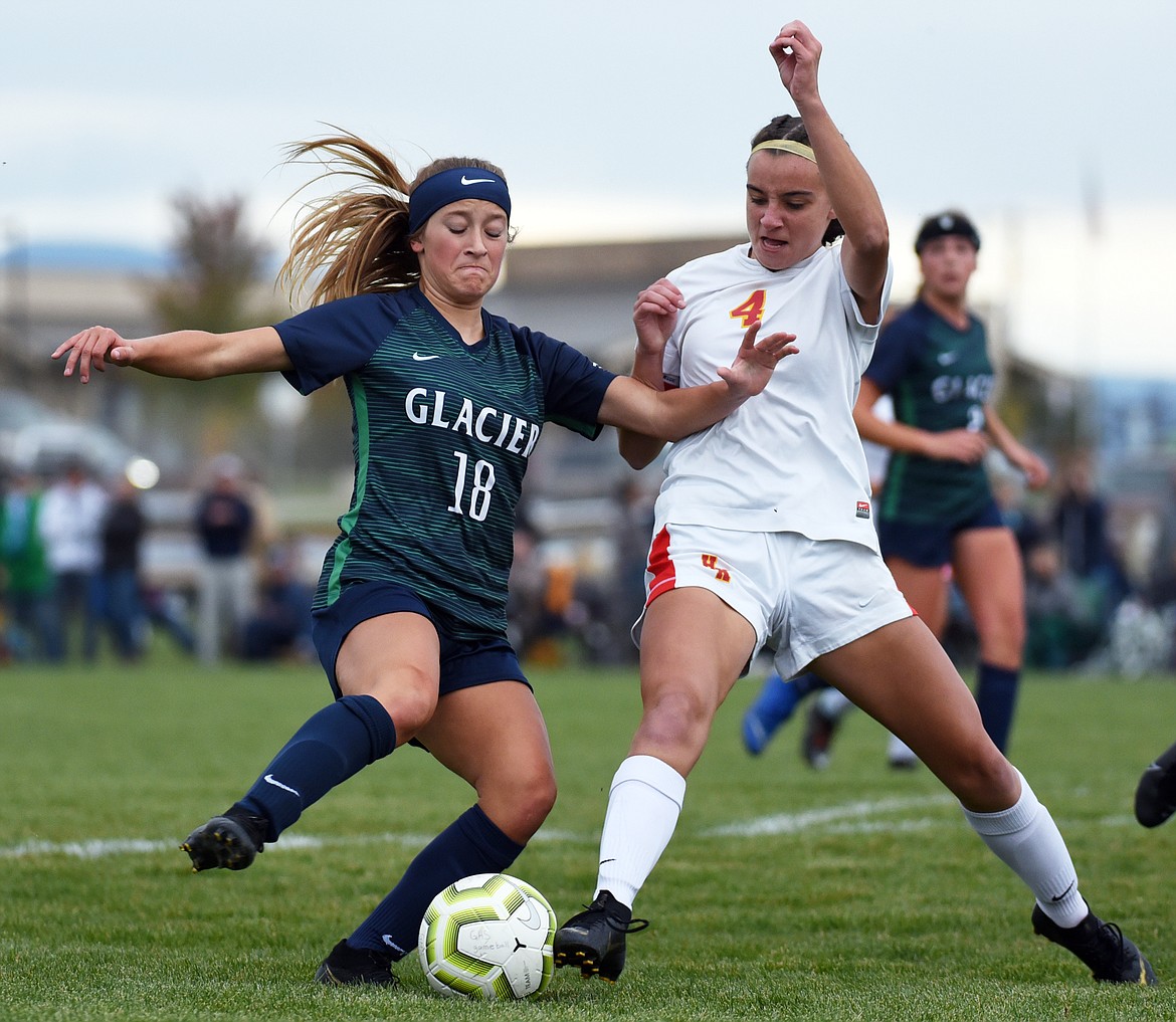 Glacier's Madison Becker (18) works against the defense of Missoula Hellgate's Elaina Pierce (4) at Glacier High School on Thursday. (Casey Kreider/Daily Inter Lake)