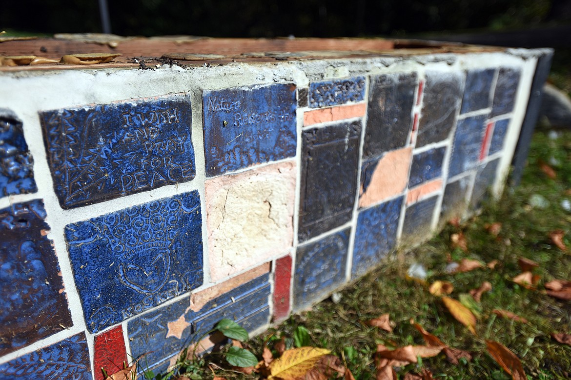 Tiles along the sides and the stone slabs that sit atop two of the four benches were removed and broken at the Community Spirit Monument in Woodland Park in Kalispell.