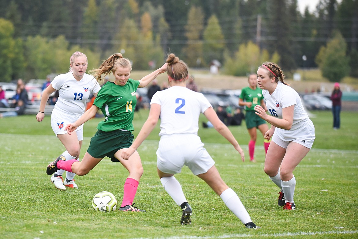 Whitefish&#146;s Josie Schneider takes on a trio of Bigfork defenders during a home match at Smith Fields. (Daniel McKay/Whitefish Pilot)