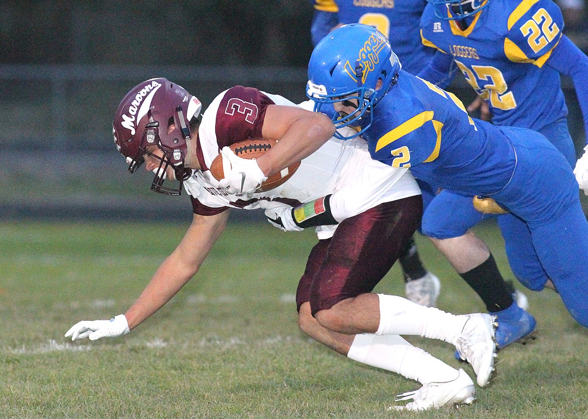 Libby junior Colton Halvorson tackles Butte Central Catholic&#146;s Trevor Neumann in first quarter Friday night. The Loggers beat the Maroons 29-21 to stay unbeaten at 6-0. (Paul Sievers/The Western News)