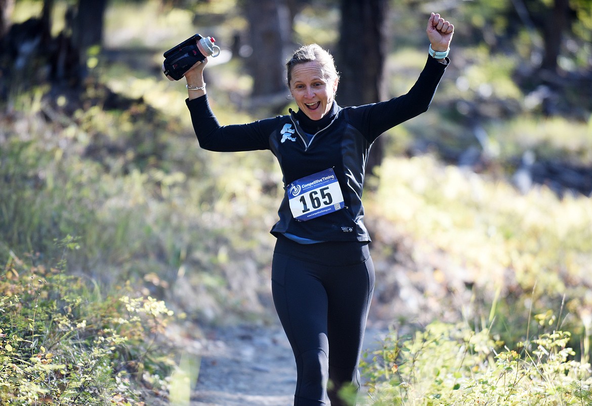 Ann Lee Maude-Simpson cheers during 5K race Sunday on the Whitefish Trail during the Whitefish Trail Legacy Run. (Heidi Desch/Whitefish Pilot)