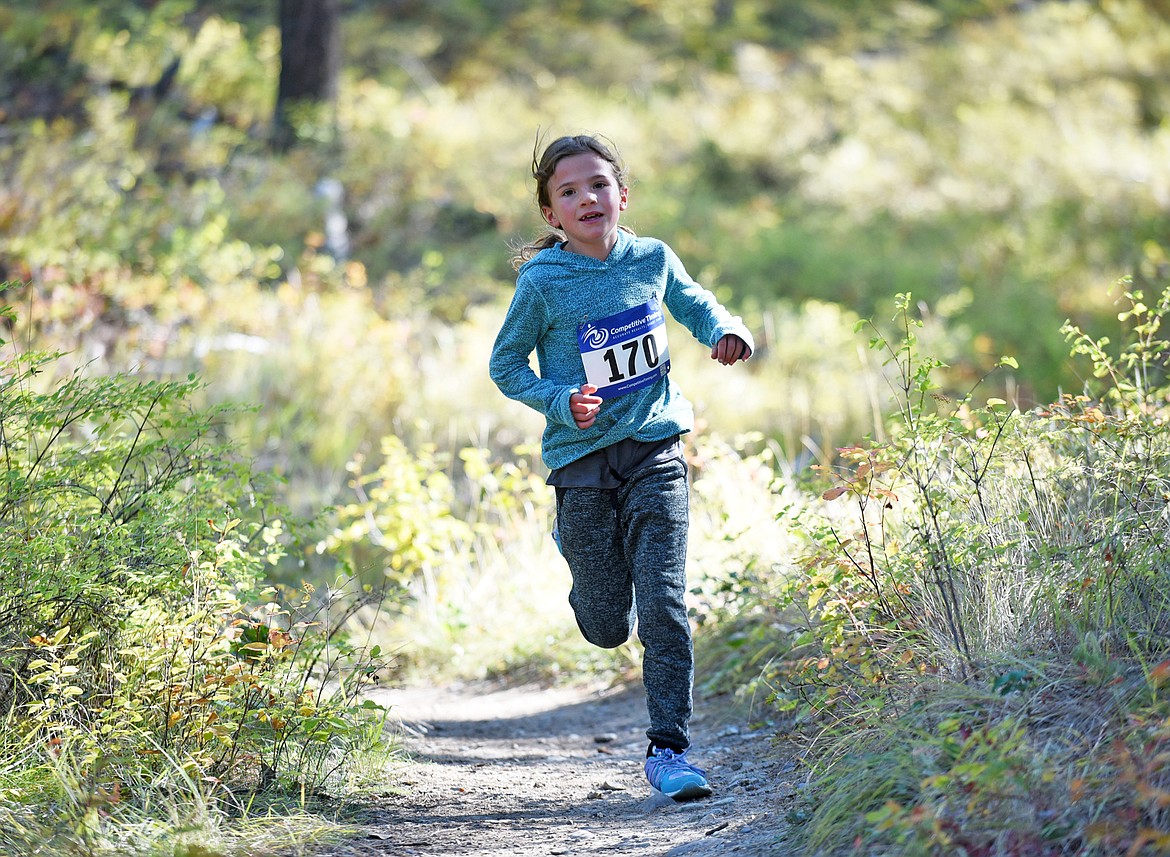 Blake Ruta, 8, of Whitefish flies down the Whitefish Trail during the fun run on Sunday morning during the Whitefish Trail Legacy Run. (Heidi Desch/Whitefish Pilot)