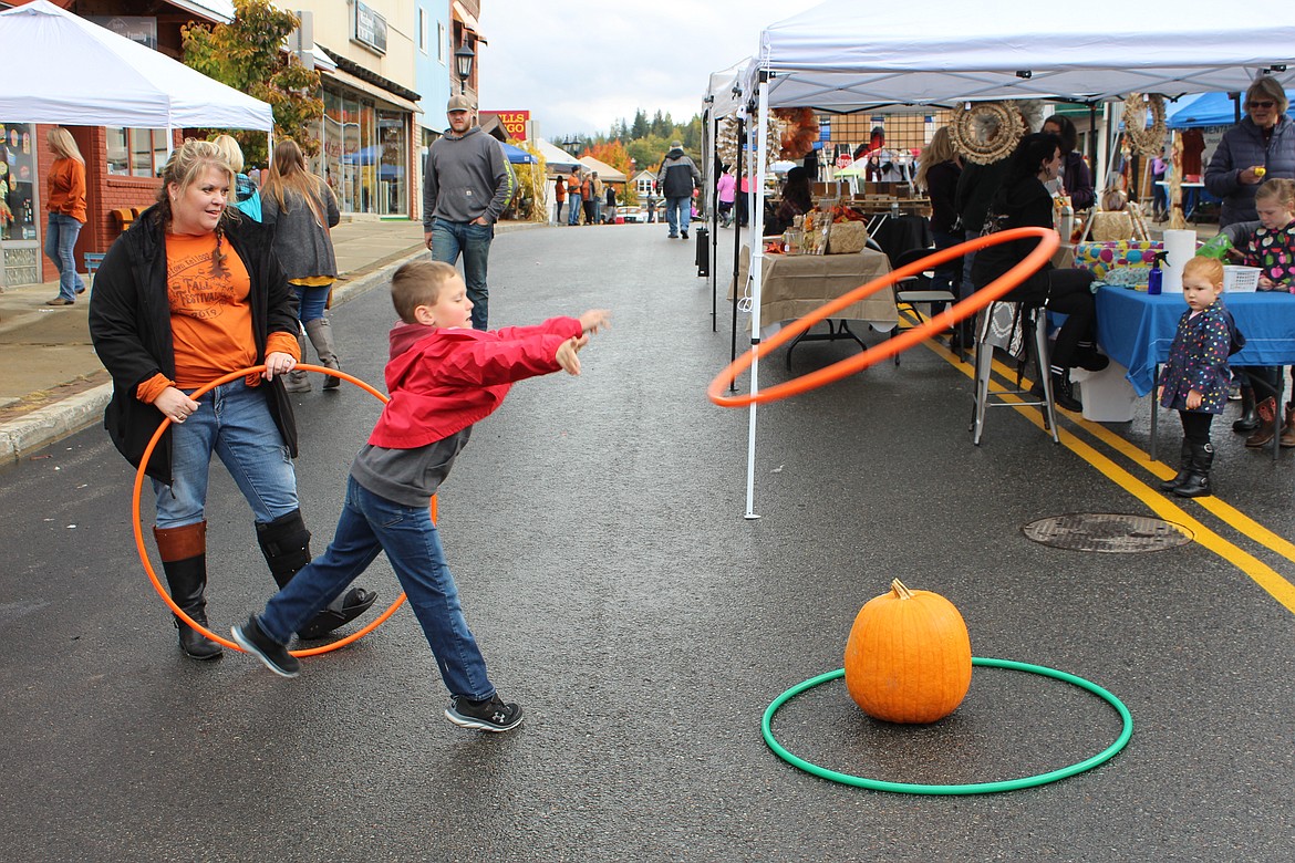 Photo by CHANSE WATSON
Lisa Beaman supervises the Hula-Hoop toss game at the Fall Festival. The event boasted nine different carnival style games on top of other activities provided by the uptown businesses.