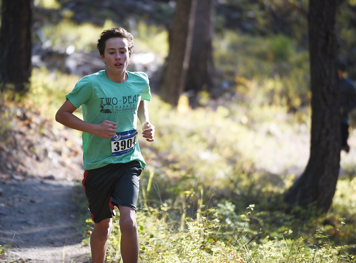 Deneb Linton, 13, of Whitefish runs in the 5K 5K race Sunday on the Whitefish Trail during the Whitefish Trail Legacy Run. (Heidi Desch/Whitefish Pilot)