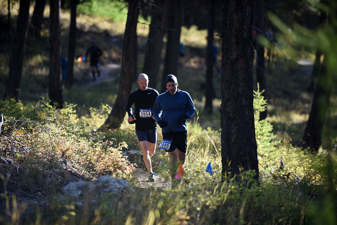 Steve Qunell and David Slette run along the Whitefish Trail near the start of the half marathon Sunday during the Whitefish Trail Legacy Run. (Heidi Desch/Whitefish Pilot)