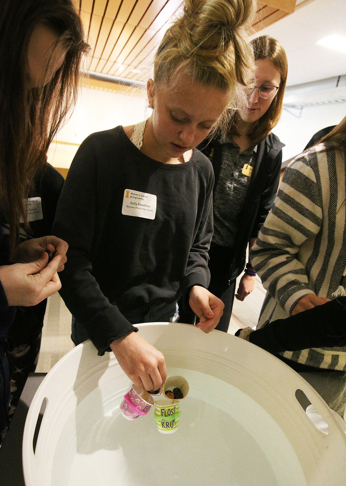 Kelly Moellmer, of Bonners Ferry High School, places a few pennies into her team&#146;s penny boat during Women in Science Day at the DeArmond College and University Center on the North Idaho College campus. (LOREN BENOIT/Press)