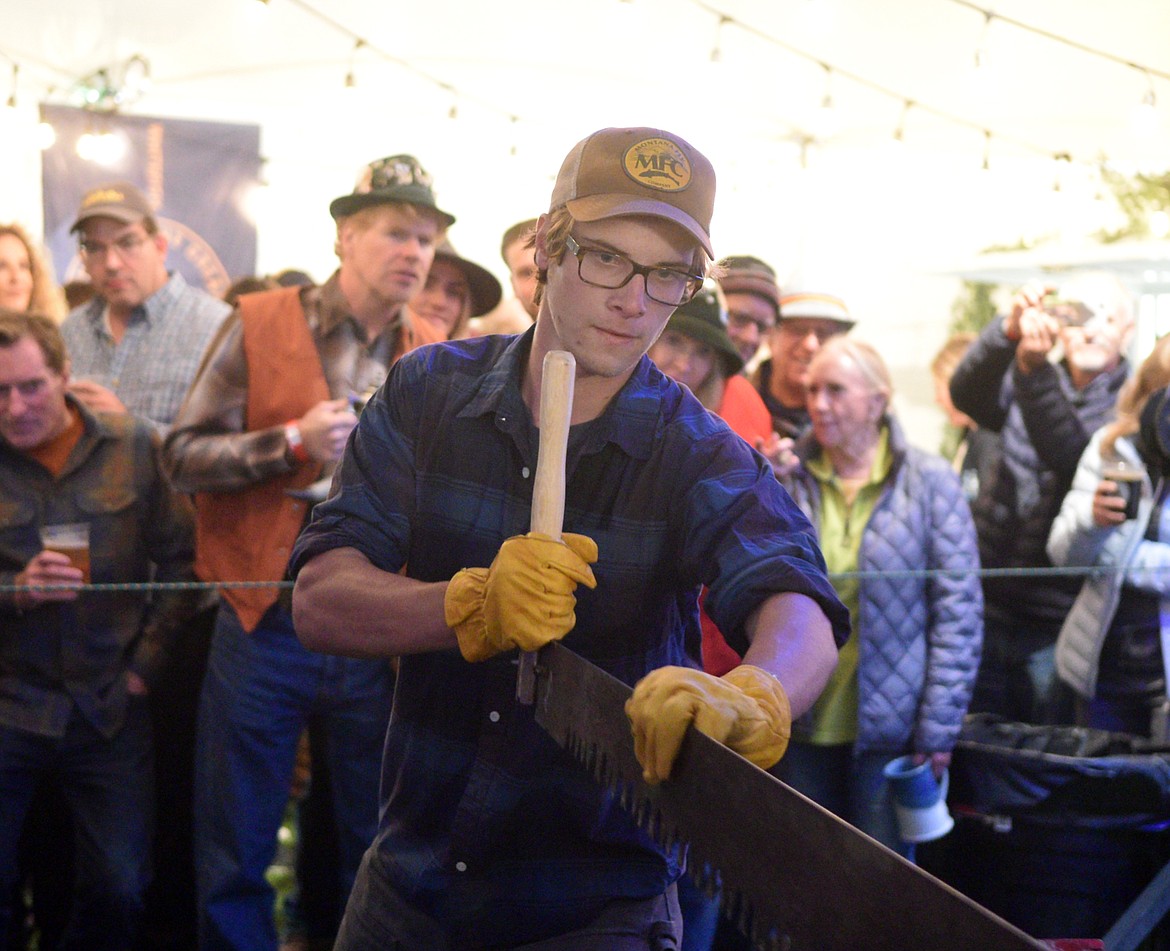 Ben Cooper competes in the men&#146;s log sawing competition Thursday night at the Great Northwest Oktoberfest. The festival continues Oct. 3-5 at Smith Fields. (Heidi Desch/Whitefish Pilot)