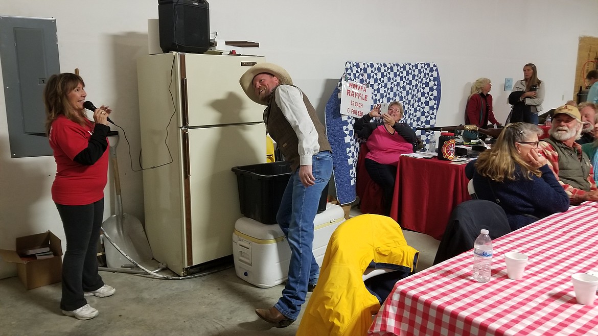 Photo by MANDI BATEMAN
Sifting through over 1,500 raffle tickets for the rifle.