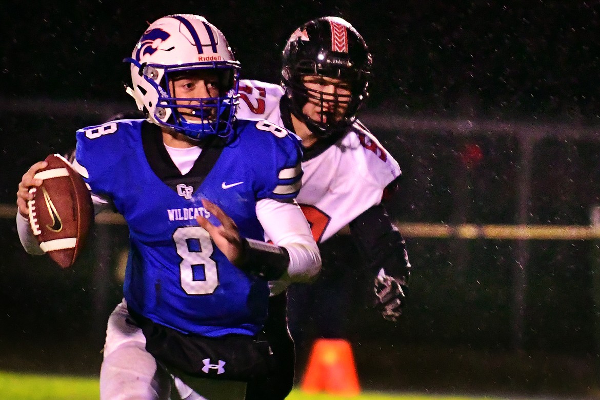 Quarterback Mason Peters fights through the rain to find a receiver in the third quarter Friday. (Jeremy Weber photo)