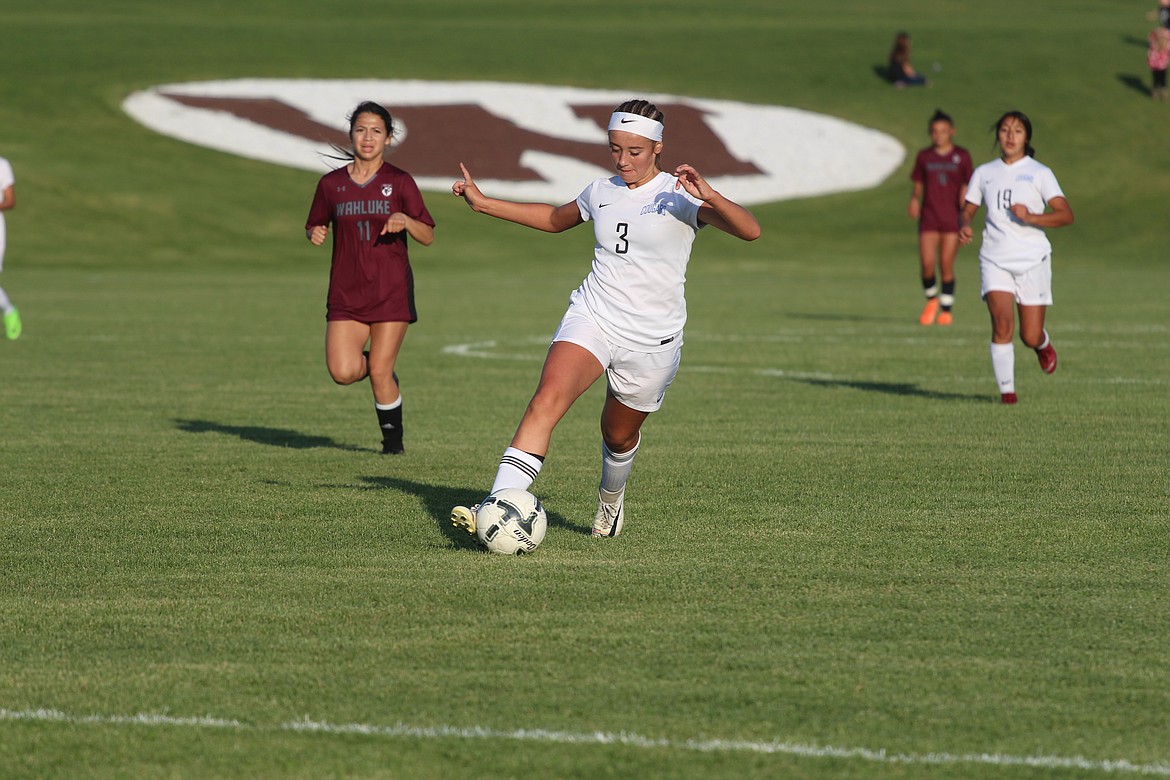 Casey McCarthy/Columbia Basin Herald Quinn Erdmann dribbles in the Wahluke half in the Cougars' 4-0 defeat on the road on Thursday.