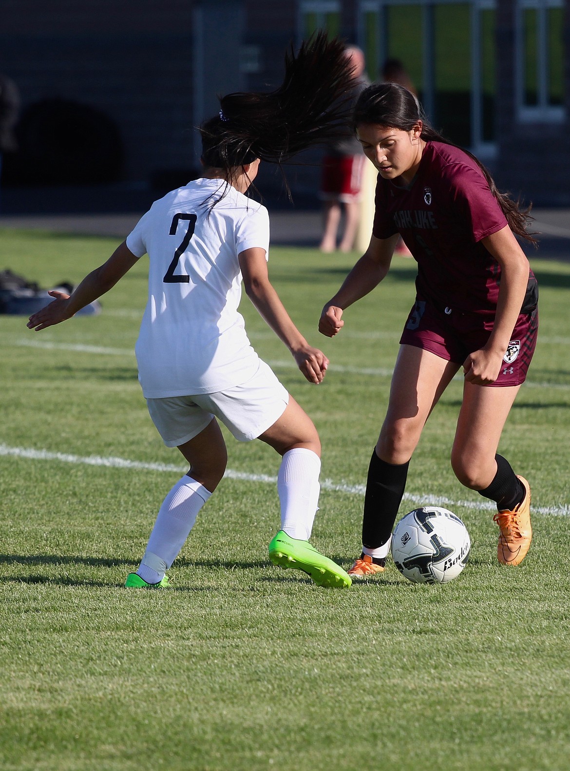 Casey McCarthy/Sun Tribune
Wahluke sophomore Alondra Lozano dribbles past Warden defender Lily Martinez (2) on the sideline last Thursday.