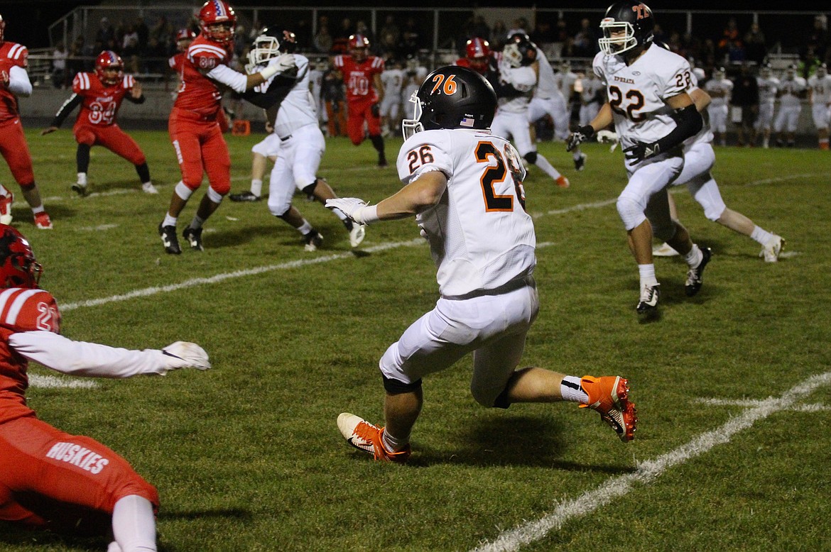 Casey McCarthy/Columbia Basin Herald The Ephrata player weaves his way through the oncoming Othello Huskies on the kickoff return in the second half on Friday night.