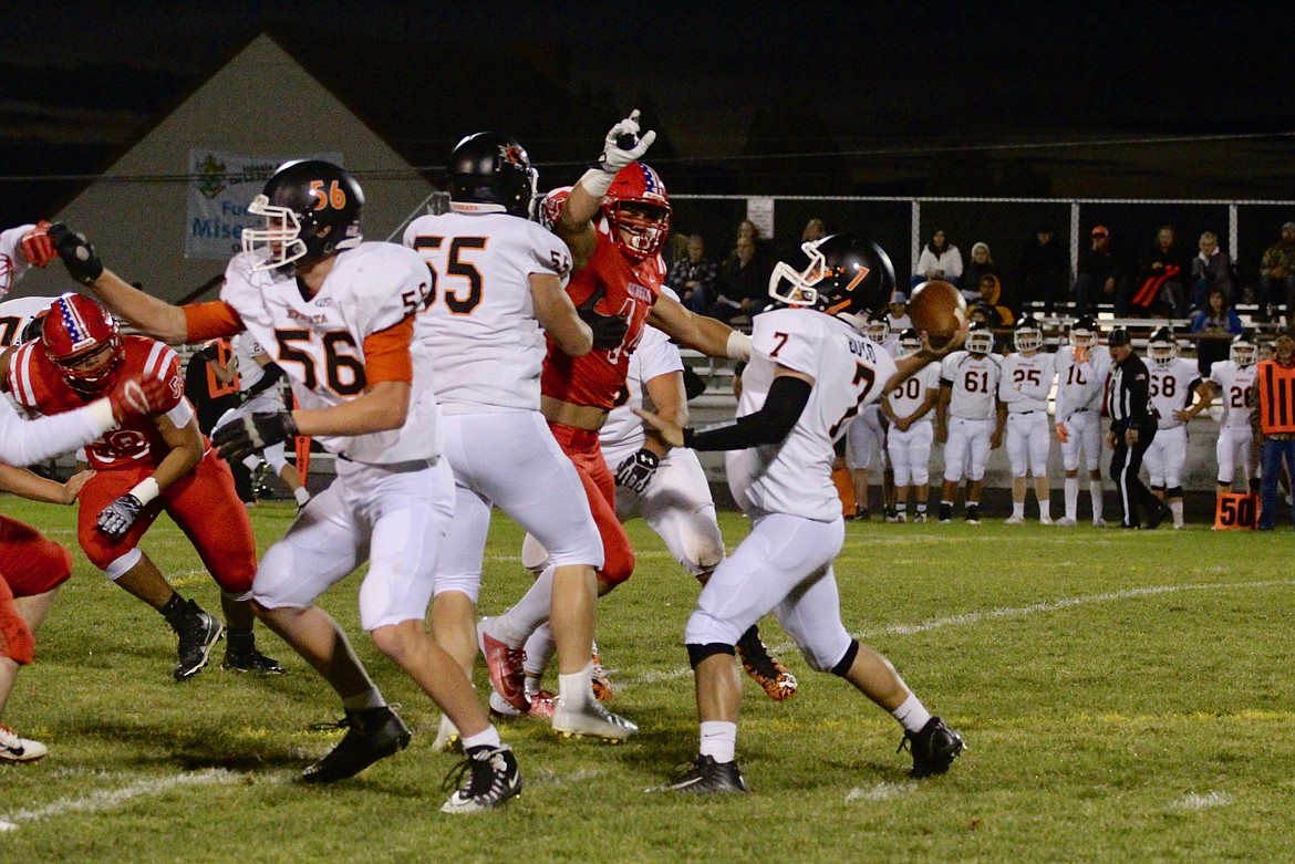 Casey McCarthy/Sun Tribune
Othello&#146;s Isaiah Perez comes in with the pressure as Ephrata quarterback Ean Boyd tries to make the pass on Friday night.