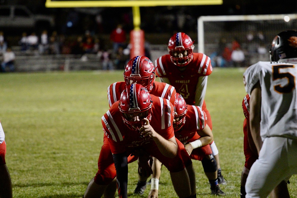 Casey McCarthy/Columbia Basin Herald Othello quarterback, and tail backs line up behind the center near the goal line on Friday night at the Othello Homecoming matchup against Ephrata.