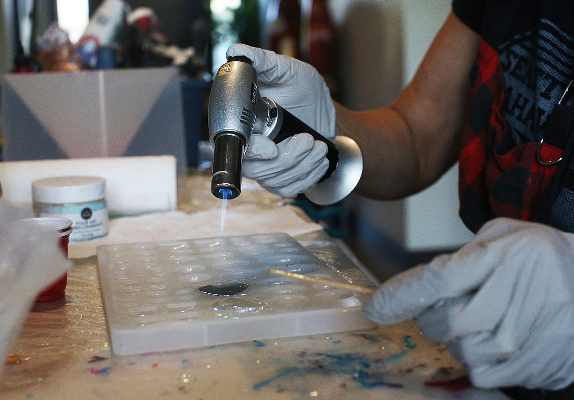 LOREN BENOIT/Press
Artist Twyla Jensen uses a butane torch to fuse resin liquid with a loved one&#146;s ashes to make jewelry.