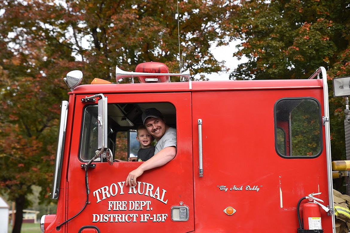 KODY HOFFMAN and his son, Kayden, drive the Troy Volunteer Fire truck in the 2019 Troy homecoming parade. (Tana Wilson/The Western News).