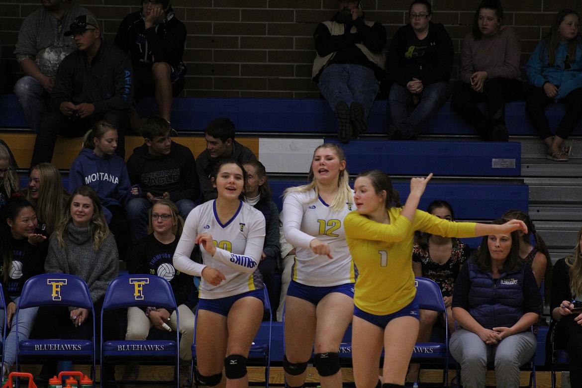 DANIELLE VANHUSS, Katie Harrington and Mckenzie Robins of Thompson Falls celebrate a point against Arlee. (John Dowd/Clark Fork Valley Press)