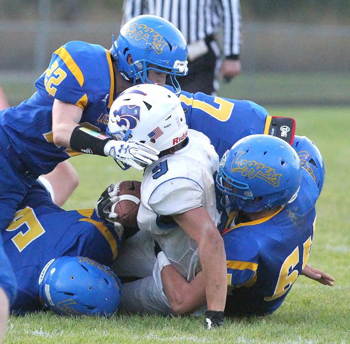 LUKE FOREMAN, left, Ryder Davis, Dave Patterson and Riley Vogel gang tackle Columbia Falls back Isaac Balla Sept. 20. (Paul Sievers/The Western News)