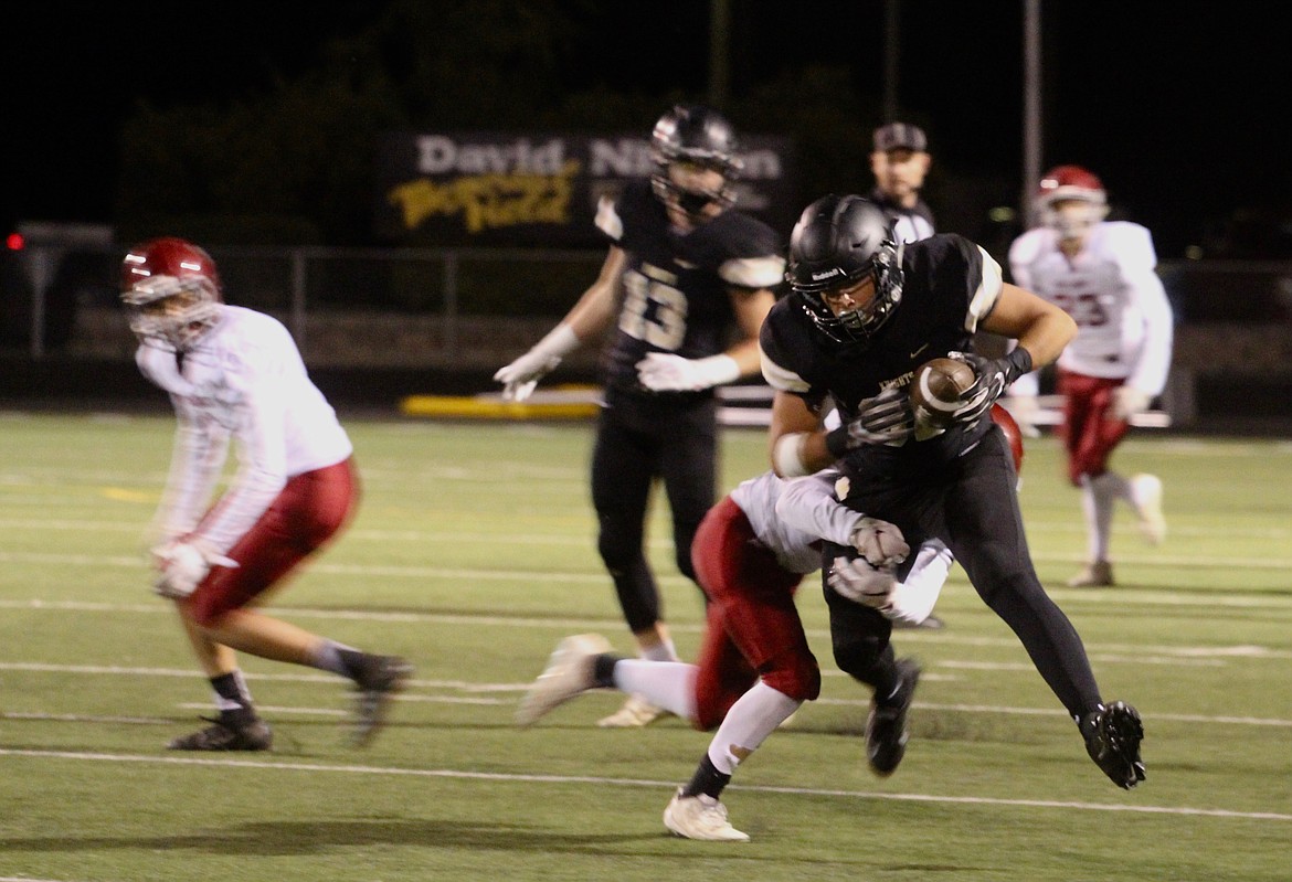 Casey McCarthy/ Columbia Basin Herald Kevin Reyes collides with the Okanogan defender after making the grab for the Knights on Friday night.