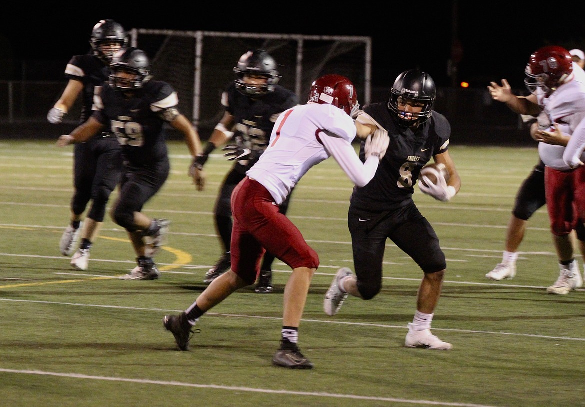 Casey McCarthy/ Columbia Basin Herald Lorenzo Myrick pushes off the Okanogan defender as he rushes forward for the Knights on Friday.