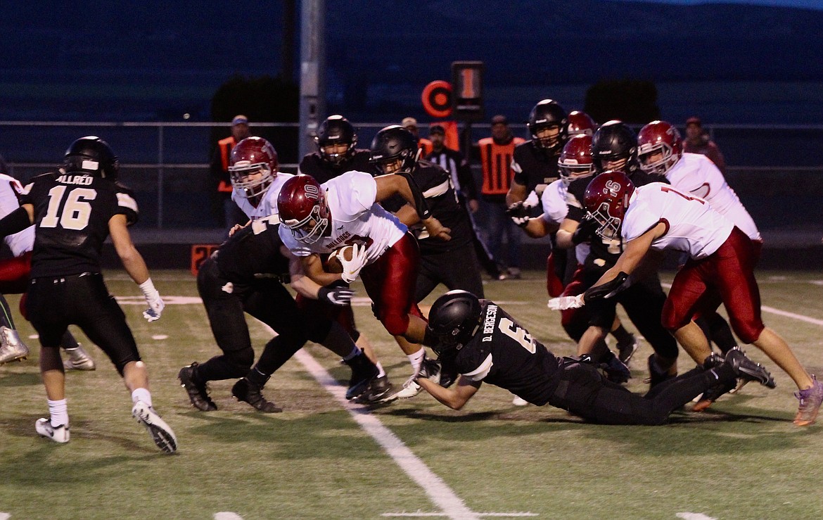 Casey McCarthy/ Columbia Basin Herald Royal High School defenders collapse on Okanogan's Kolbe Tvolberg during the first half against the Bulldogs on Friday.