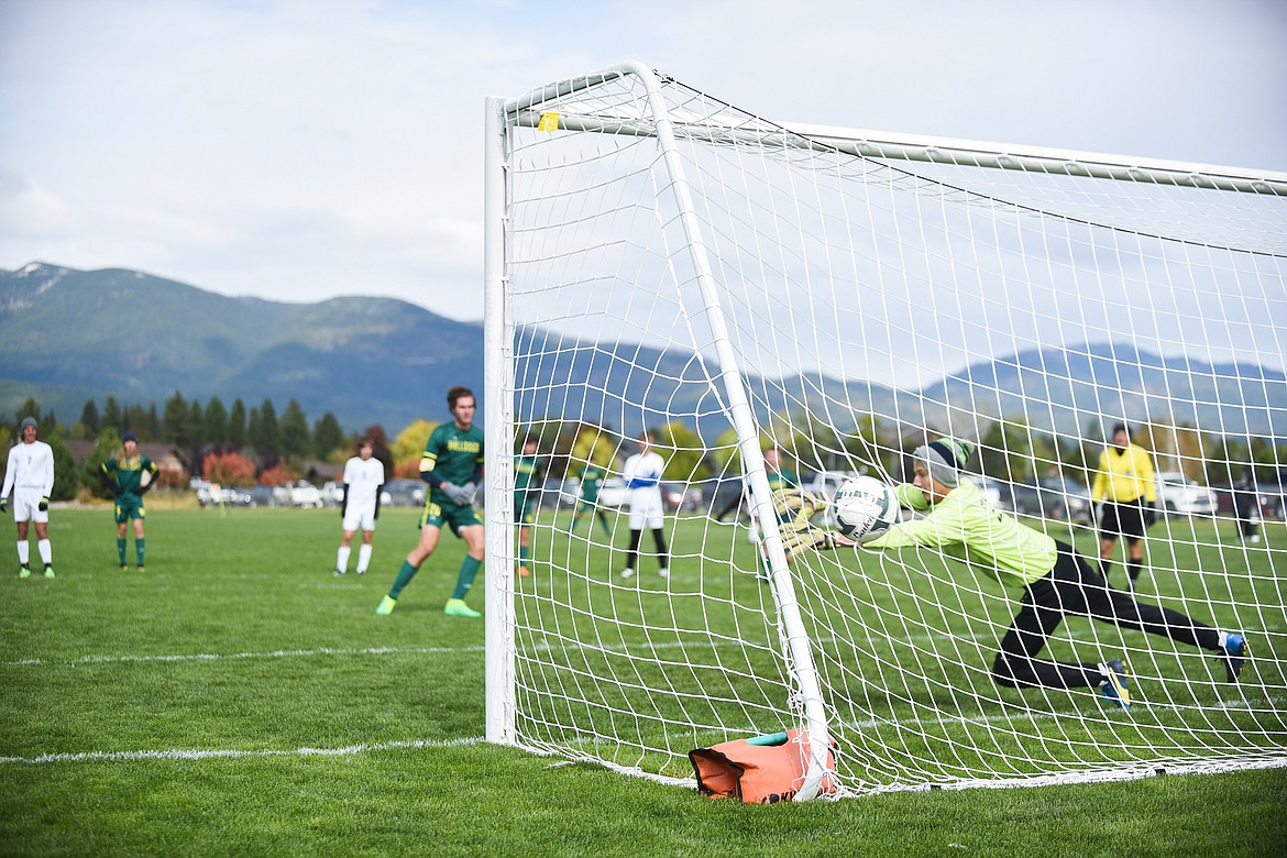 Sam Menicke scores on a penalty kick during Saturday&#146;s homecoming win over Libby. (Daniel McKay/Whitefish Pilot)