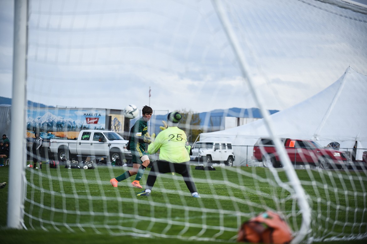 Ian Lacey shoots past the keeper during Saturday&#146;s homecoming win over Libby. (Daniel McKay/Whitefish Pilot)